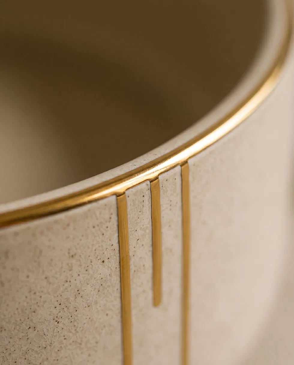 Detail of the Lumure bowl's gold-lustre rim and hand-drawn gold lines.